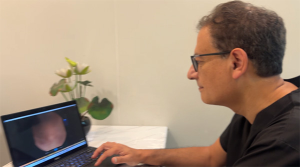 Dr Pranab Gyawali reviewing images from a capsule endoscopy recording on a computer screen.