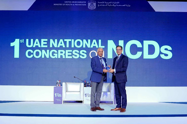 Dr Pranab Gyawali receiving a token of appreciation on stage at the UAE National Congress on NCDs